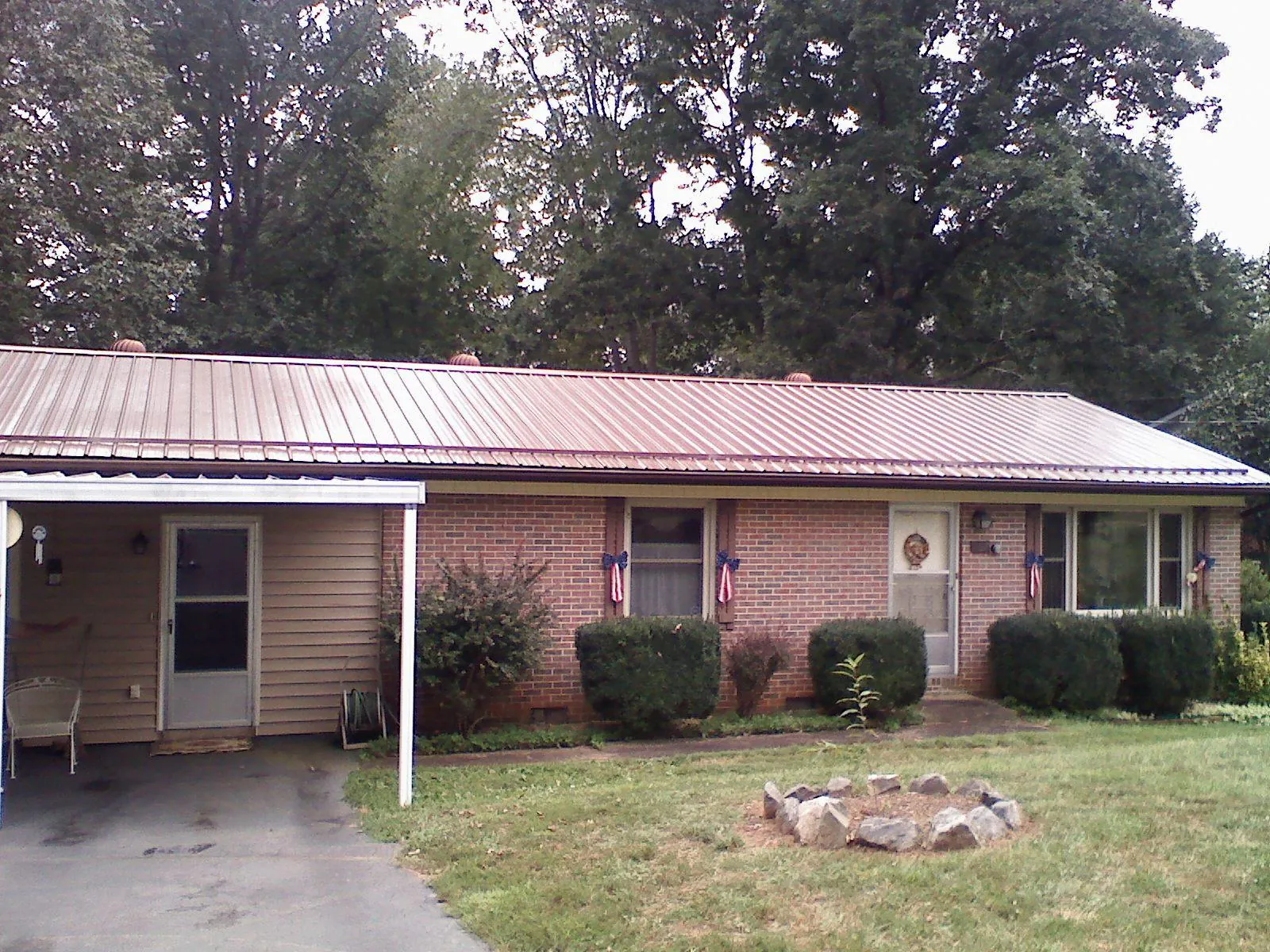 Bronze metal roof and carport on a brick ranch home — Roof Repair work by our crew in Lewiston